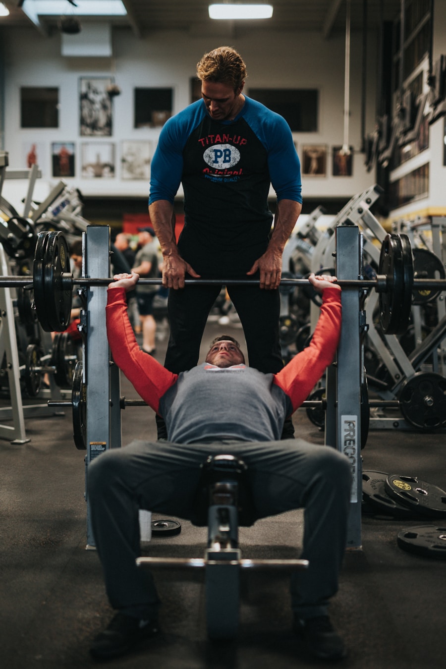 A coach spotting a lifter through a bench press
