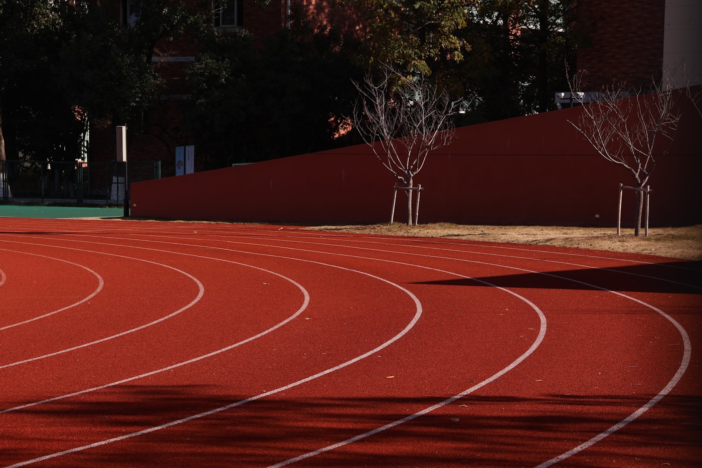 The curved lanes of an empty outdoor running track